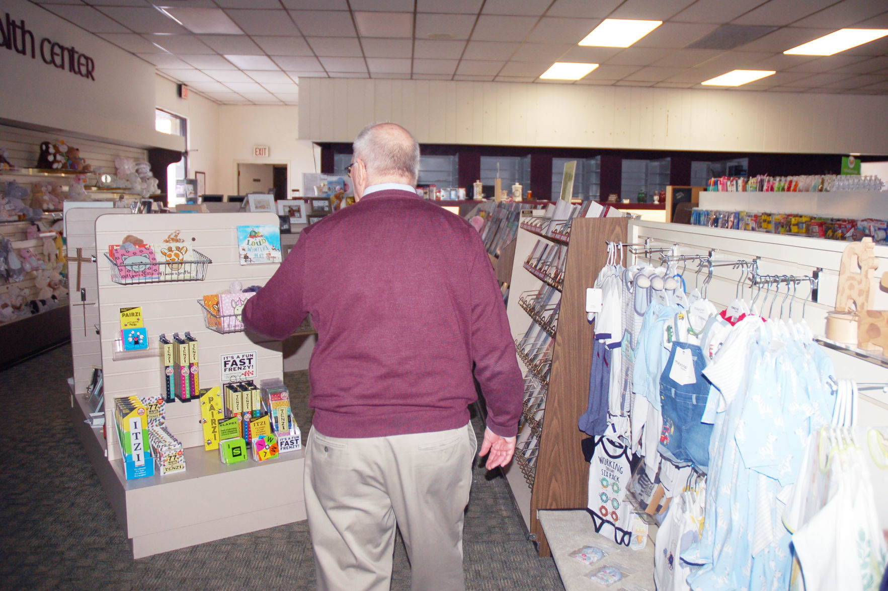 Store owner Jim McCullough walks through store on closing day